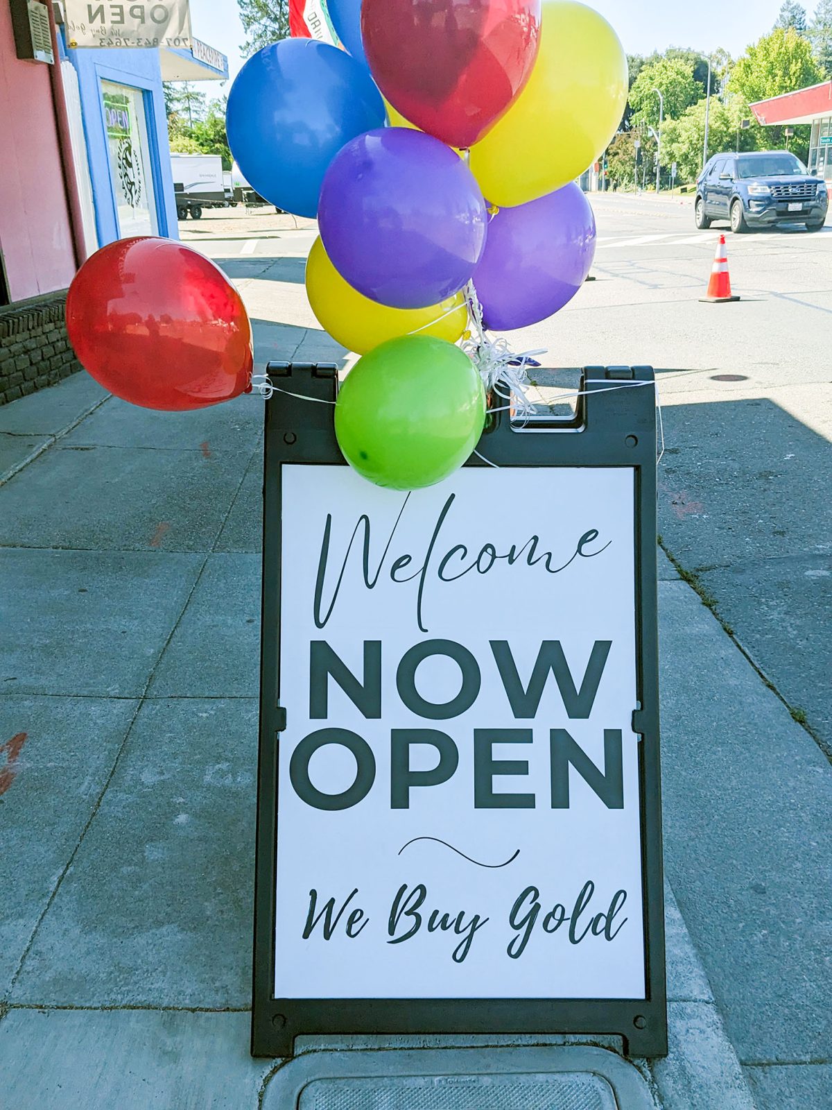 We Are Now Open sign in the window at Abby's Pawn & Coin